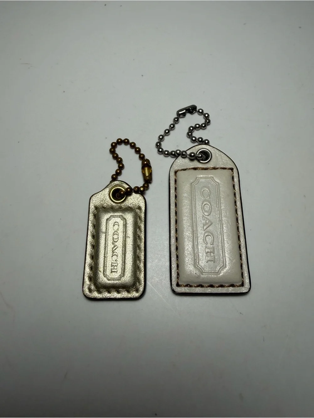 Coach Leather Tag Keychain Duo in Metallic Gold and White